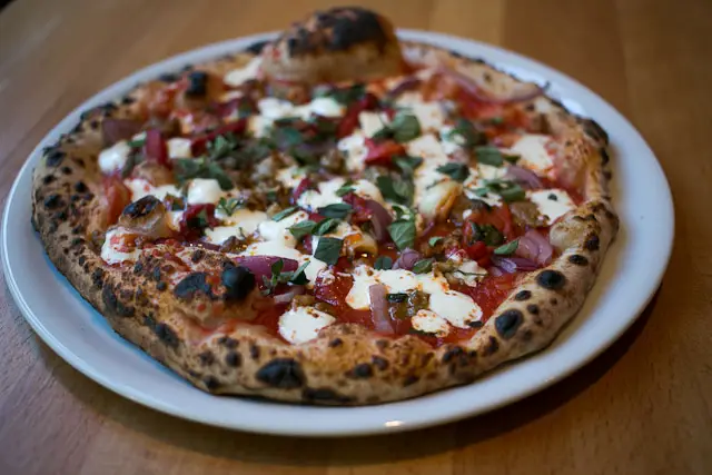 The "Street Fair" pizza at Brooklyn Central has mozzarella, red sauce, sausage, peppers and onions and costs $16, 